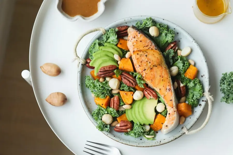 A replica of the restaurant's signature salad, salmon, !ï¸ avocado and nut salad step 0