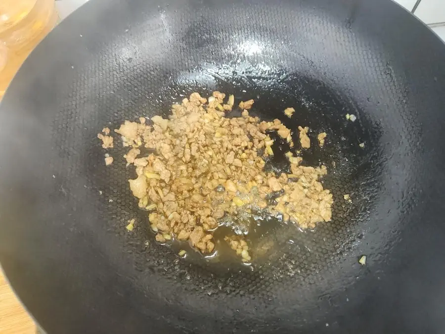 Stir-fry minced pork belly with garlic sprouts and serve as part of the meal step 0