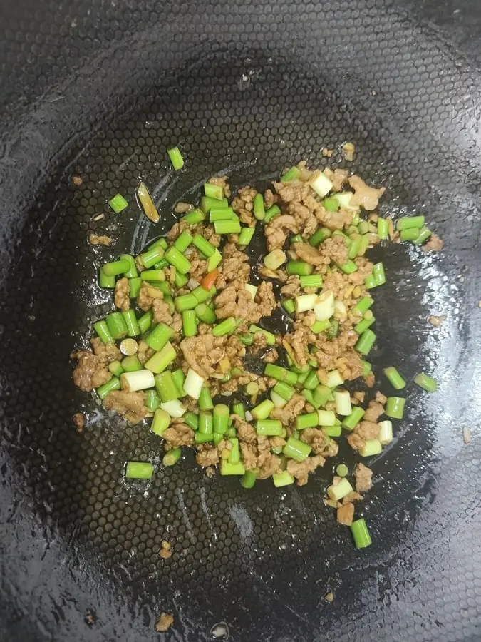 Stir-fry minced pork belly with garlic sprouts and serve as part of the meal step 0