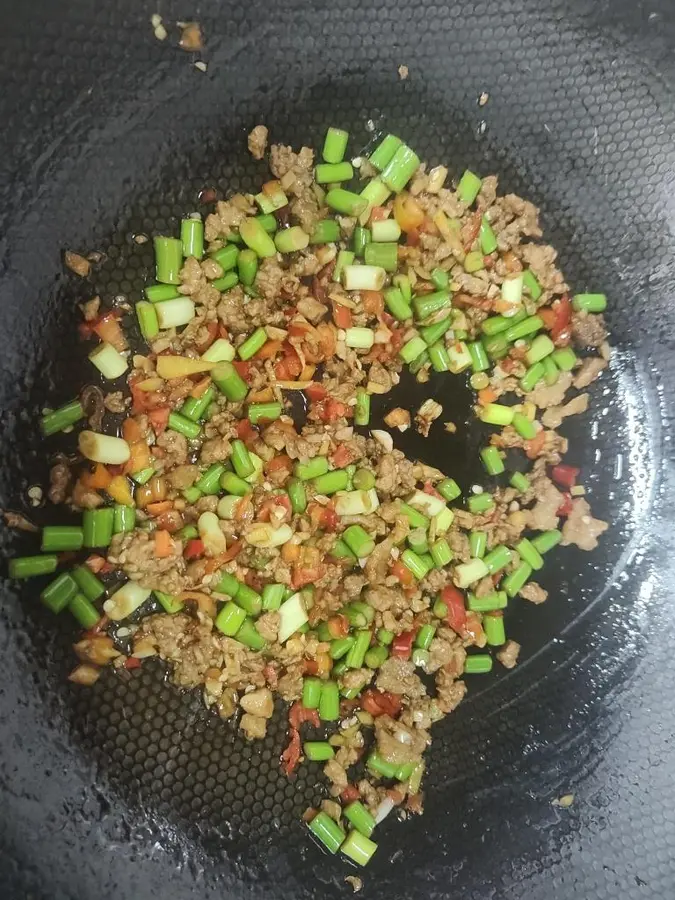 Stir-fry minced pork belly with garlic sprouts and serve as part of the meal step 0