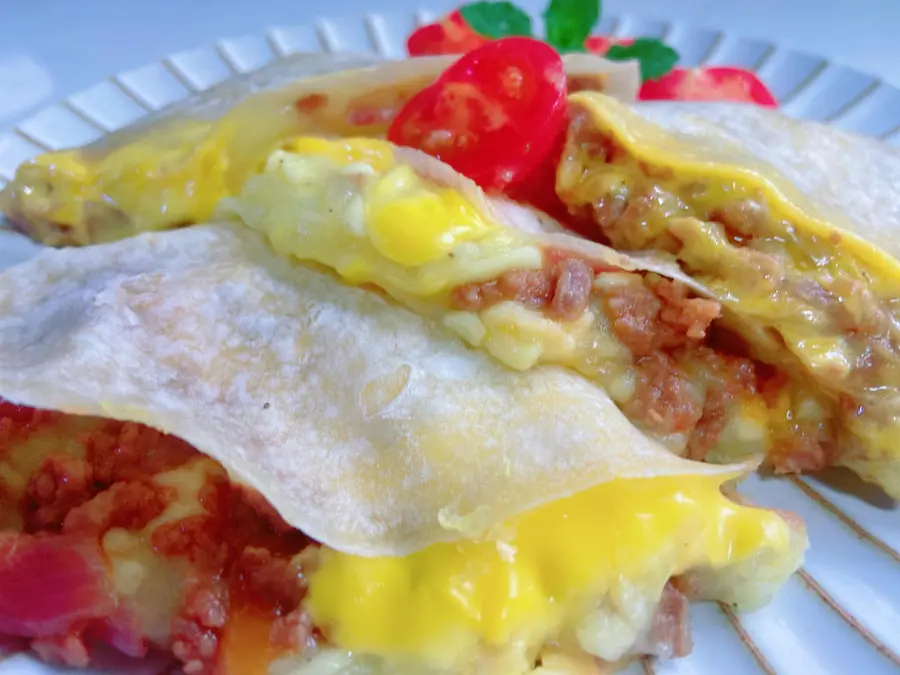 A bite of the beef patty with mashed potatoes and cheese in the sauce step 0