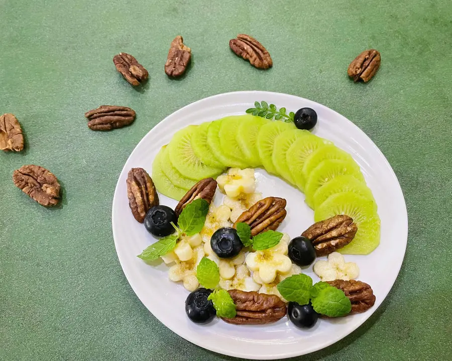 A creative platter of pecans and fruits step 0