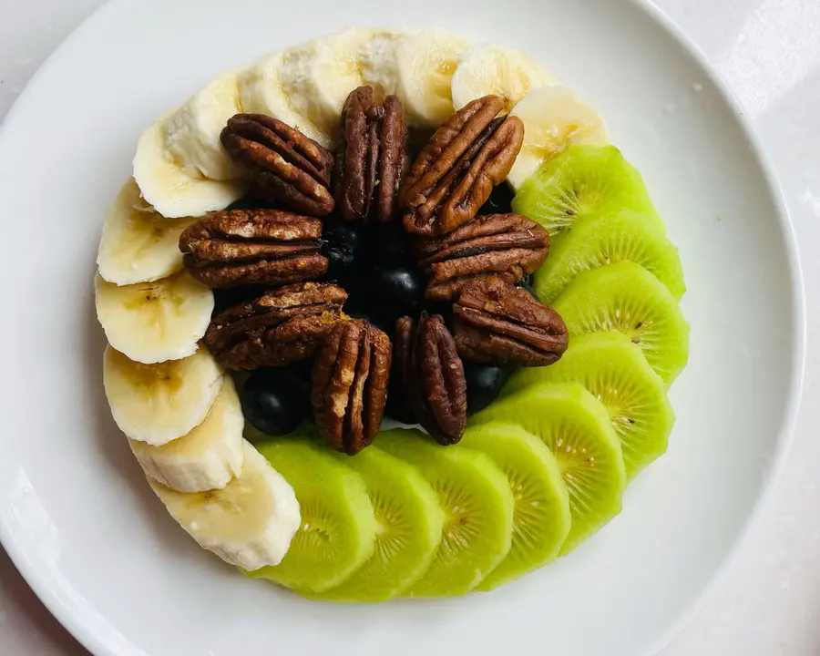 A creative platter of pecans and fruits step 0